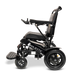 Side view of the sleek, modern black ComfyGo MAJESTIC IQ-9000 Auto Folding Electric Wheelchair featuring a digital joystick controller and brushless silent motors, its design includes a comfortable seat, footrest, and large rear wheels against a plain black background.