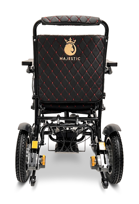 The image showcases the ComfyGo MAJESTIC IQ-9000 Auto Folding Electric Wheelchair, featuring a sleek black design with red stitching and the brand name "Majestic" on the backrest. It is equipped with brushless silent motors and a digital joystick controller, complemented by large rear wheels and smaller front wheels to enhance mobility and comfort.