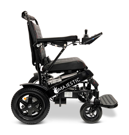 The ComfyGo MAJESTIC IQ-9000 Auto Reclining Electric Wheelchair features the Majestic logo, padded seat, armrests, right-side digital joystick, large rear wheels, and footrest. Made from aircraft-grade aluminum alloy and shown side view on a white background.