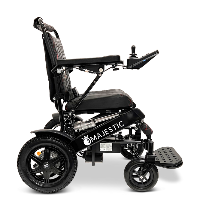 Side view of a foldable electric wheelchair with the brand name ComfyGo on its frame. The ComfyGo MAJESTIC IQ-9000 Auto Folding Electric Wheelchair features a digital joystick controller on the right armrest, padded seat, and large rear wheels with brushless silent motors and a small caster wheel at the front.