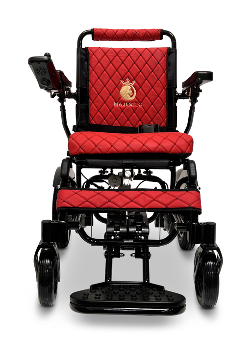 The ComfyGo MAJESTIC IQ-9000 Auto Folding Electric Wheelchair, designed in red and black with a quilted pattern and a gold logo on the backrest, includes armrests and a footplate. It features brushless silent motors and is equipped with an IQ-9000 AR digital joystick controller, showcased from the front against a black background.