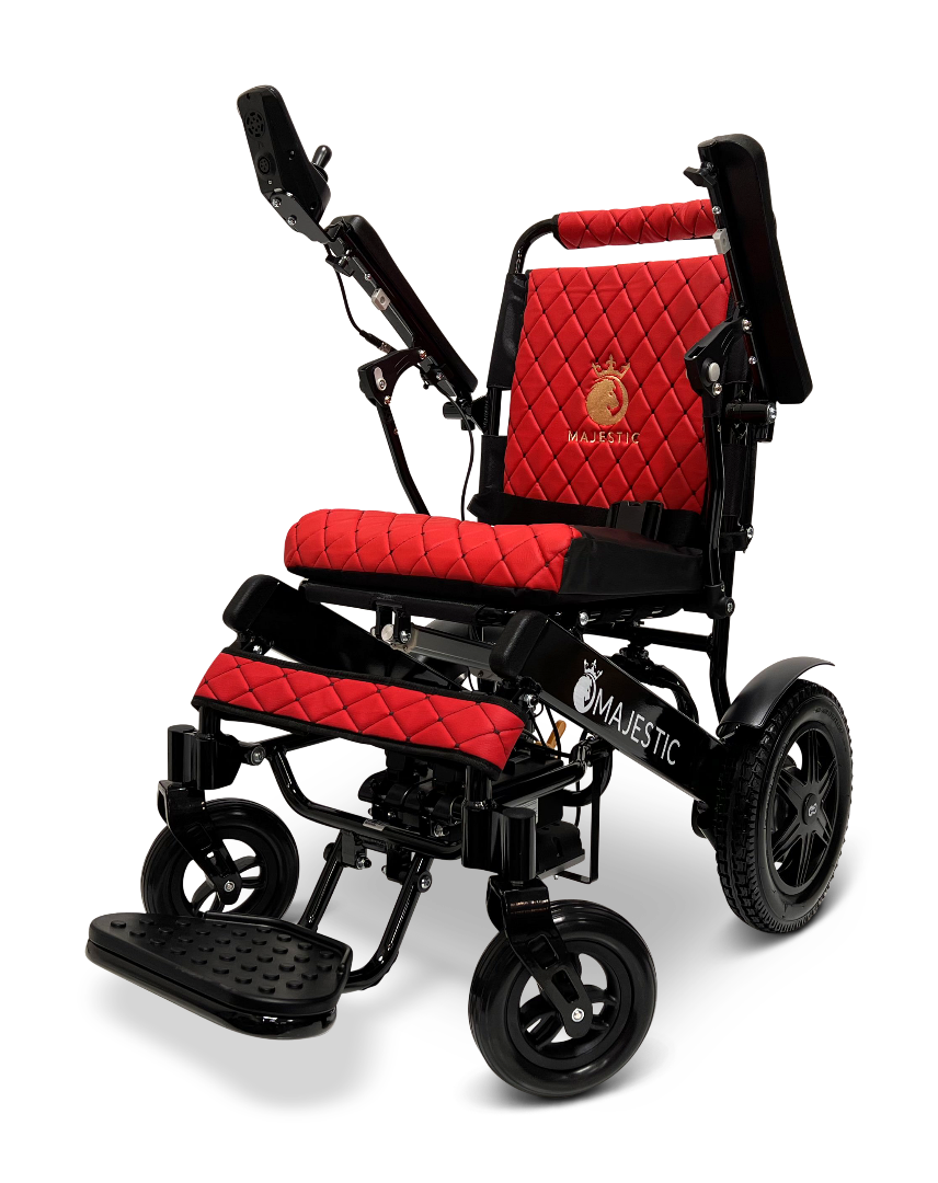 The ComfyGo MAJESTIC IQ-9000 Auto Reclining Electric Wheelchair features a black aircraft-grade aluminum alloy frame, padded red quilted seat and backrest with Majestic logo, footrest, and a digital joystick controller on the armrest.