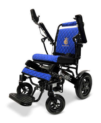 The ComfyGo MAJESTIC IQ-9000 Auto Reclining Electric Wheelchair features black and blue quilted upholstery, large rear wheels, adjustable armrests, a footrest, and a digital joystick controller. The Majestic logo is displayed on the seat and frame.