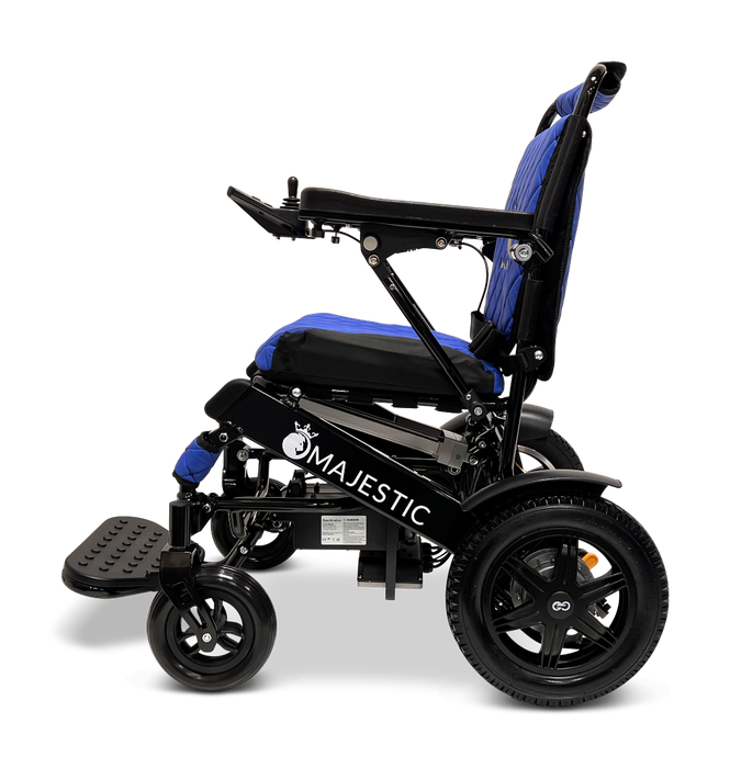 Side view of a blue ComfyGo MAJESTIC IQ-9000 Auto Folding Electric Wheelchair with a black frame and the brand name Majestic displayed on the side. This model features large rear wheels, a foldable footrest, and an advanced digital joystick controller for smooth navigation against a black background.