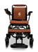 The ComfyGo MAJESTIC IQ-9000 Auto Folding Electric Wheelchair is a black and brown model featuring quilted seat and back cushions, brushless silent motors for a smooth ride, armrests, a footrest, and a digital joystick controller. The Majestic logo is elegantly embroidered on the backrest.