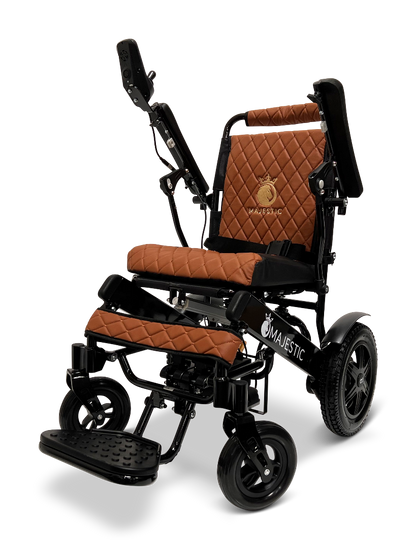 The ComfyGo MAJESTIC IQ-9000 Auto Reclining Electric Wheelchair features brown quilted cushions, a black aircraft-grade aluminum alloy frame, adjustable armrests and footrest, plus the Majestic logo embroidered on the seat back.