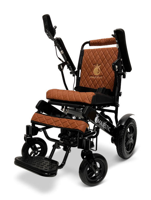 The sophisticated ComfyGo MAJESTIC IQ-9000 Auto Folding Electric Wheelchair showcases elegant black frames paired with brown quilted cushioning. It is equipped with a digital joystick controller, silent brushless motors, adjustable components, and an accommodating footrest. The MAJESTIC logo is prominently featured on both the frame and backrest.