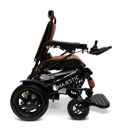 A side view of the ComfyGo MAJESTIC IQ-9000 Auto Reclining Electric Wheelchair in black and orange, featuring brushless silent motors, a digital joystick controller, large rear wheels, and a footrest.