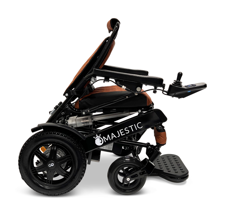 Side view of a black and brown ComfyGo MAJESTIC IQ-9000 Auto Folding Electric Wheelchair, featuring the advanced IQ-9000 AR digital joystick controller on the armrest. The Majestic branding is evident on the side, highlighting its brushless silent motors, robust wheels, and a cushioned seat designed for maximum comfort.