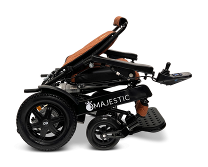 A black ComfyGo MAJESTIC IQ-9000 Auto Folding Electric Wheelchair featuring large rear wheels and a brown cushioned seat, shown from the side. Equipped with a digital joystick controller on the right armrest, this model is powered by brushless silent motors and includes front footrests to ensure optimal comfort.