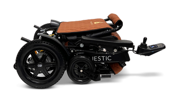 Introducing the ComfyGo MAJESTIC IQ-9000 Auto Folding Electric Wheelchair in a neatly folded design with a brown and black finish. It features the advanced IQ-9000 AR digital joystick controller and large rear wheels, powered by brushless silent motors for smooth operation. This compact wheelchair is perfect for easy transport and storage.