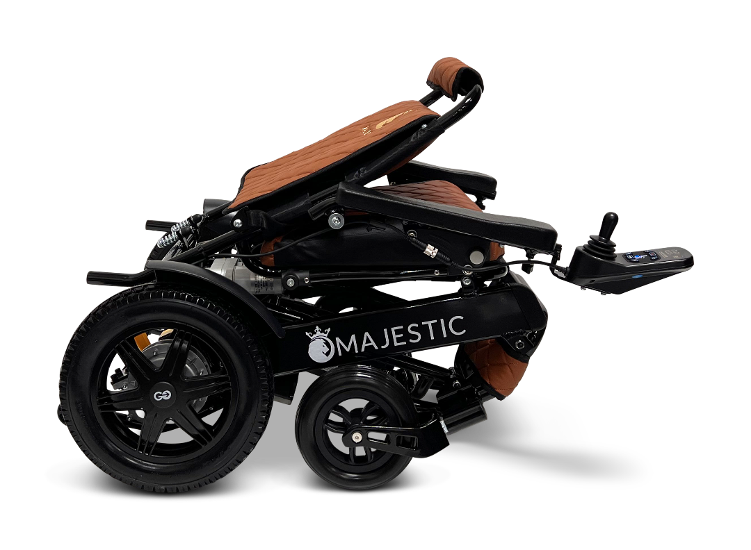 ComfyGo MAJESTIC IQ-9000 Auto Folding Electric Wheelchair includes brushless silent motors, large rear wheels, and a cushioned seat. It features an IQ-9000 AR digital joystick controller mounted on an armrest, all presented against a sleek black background.