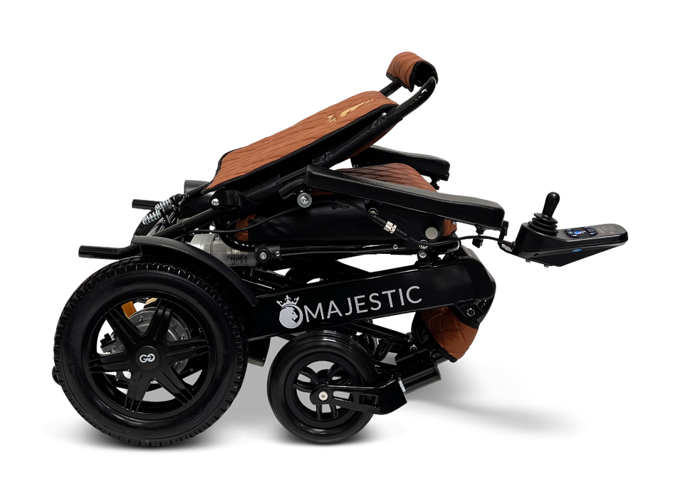 ComfyGo MAJESTIC IQ-9000 Auto Folding Electric Wheelchair includes brushless silent motors, large rear wheels, and a cushioned seat. It features an IQ-9000 AR digital joystick controller mounted on an armrest, all presented against a sleek black background.