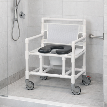 The IPU Oversize Open Front Bariatric Rolling Shower Chair Commode, featuring a white PVC frame, black padded seat, caster wheels, and mesh backrest, is placed in a tiled accessible shower with a handheld showerhead and grab bar.