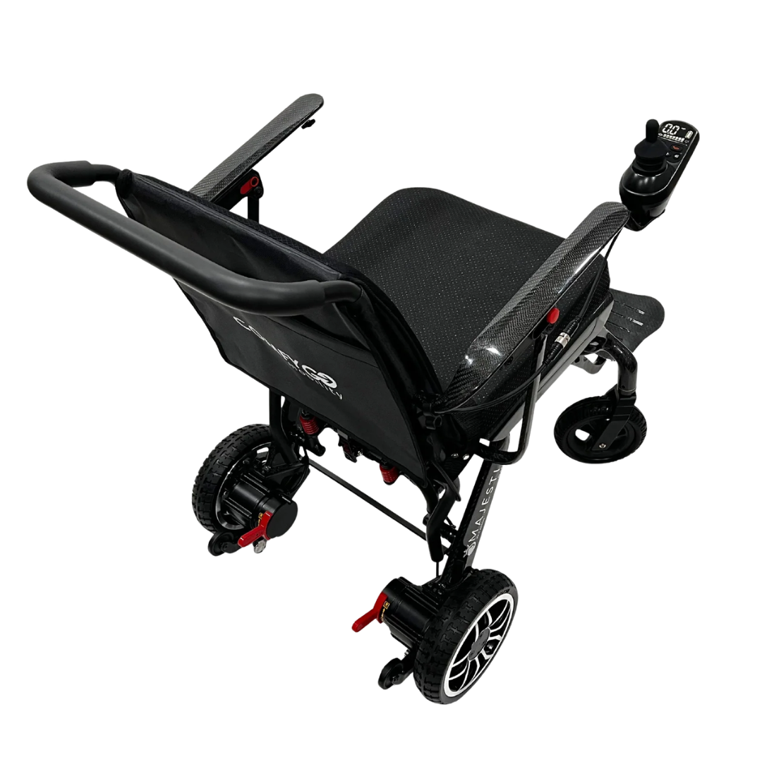 The ComfyGo IQ-Carbon Lightweight Carbon Fiber Electric Wheelchair, shown from a rear side angle on a white background, features large rear wheels, right armrest joystick control, and red wheel lock accents.