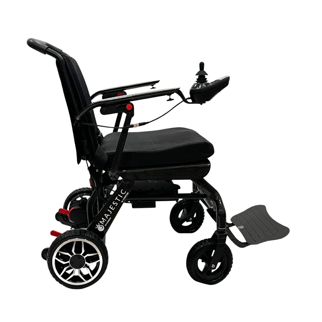A side view of the ComfyGo IQ-Carbon Lightweight Carbon Fiber Electric Wheelchair shows a black model with right armrest joystick control, foldable footrest, and large rear wheels against a white background.