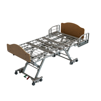 Invacare CS600™ Adjustable Long Term Care Bed | Expandable Width features a wooden headboard and footboard, secure side rails, and caster wheels. The elevated frame is shown empty, highlighting its adjustable sections and sturdy support structure.