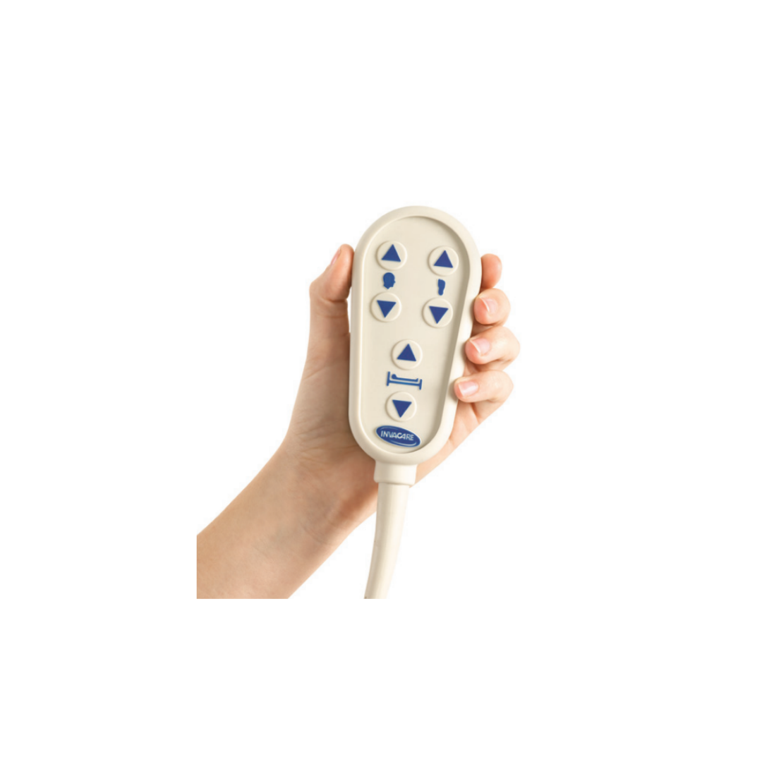 A hand holds an Invacare G-Series Bariatric Full Electric Hospital Bed G5510 remote control with blue arrow buttons for adjusting the head, foot, and overall height.