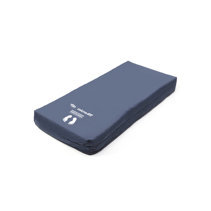 The Invacare microAIR® MA500 Alternating Pressure Low Air Loss Mattress System is a dark blue rectangular hospital mattress with a smooth surface, printed white footprints, and the brand name and logo on the cover for advanced pressure relief.