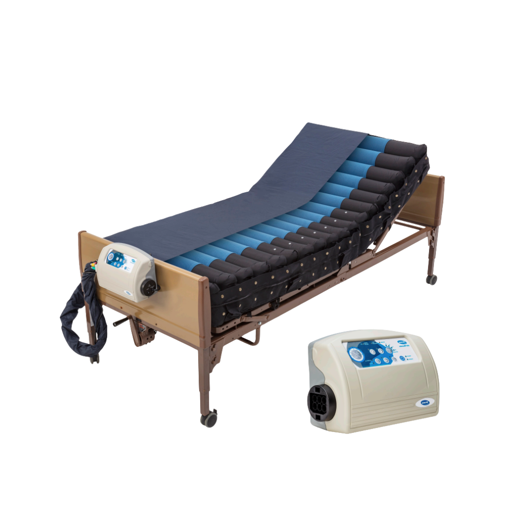 A hospital bed with the Invacare microAIR® MA600 3-in-1 Alternating Pressure LAL Mattress System in blue and black, partly elevated. An electronic control unit is attached to the bed and also shown separately in the foreground.