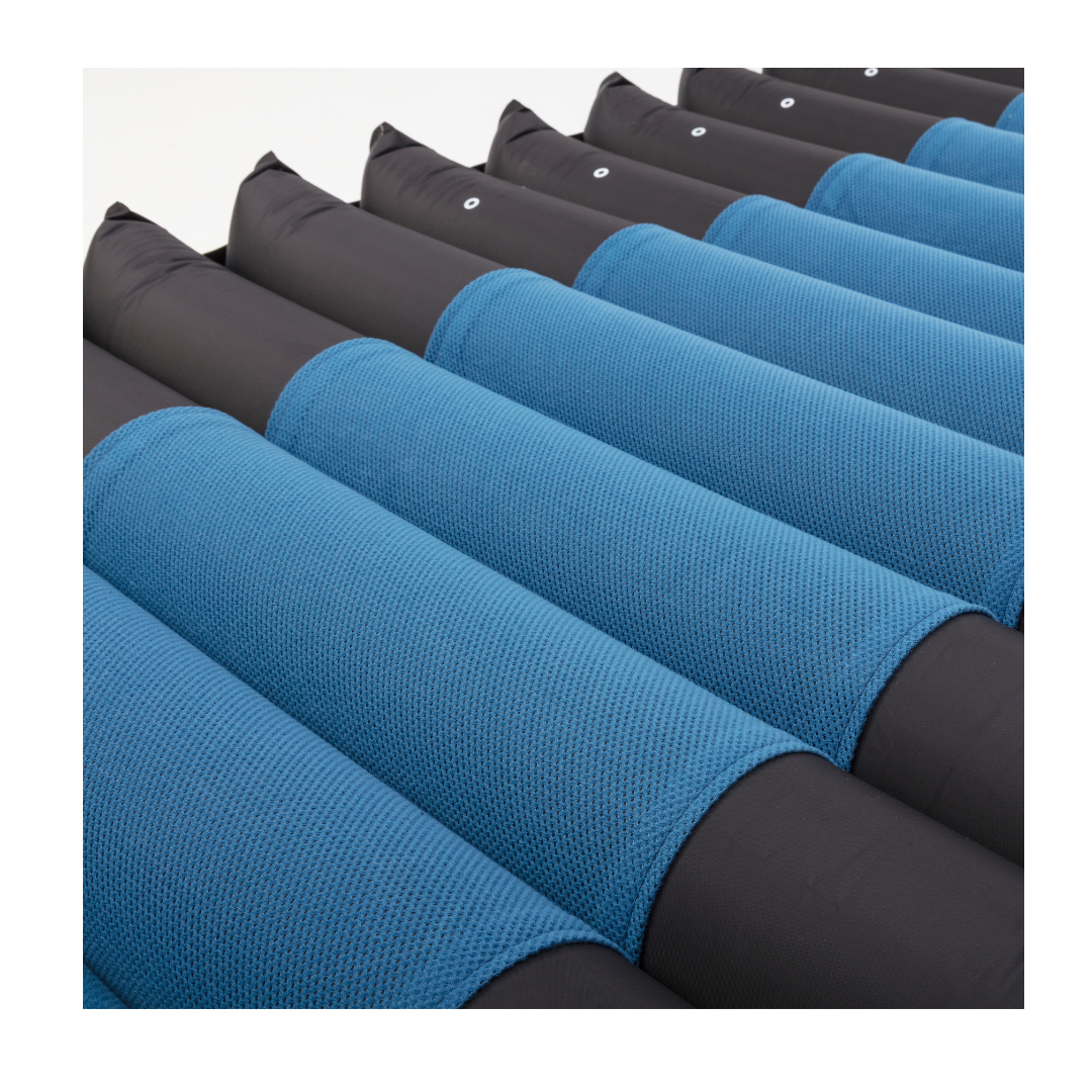 Close-up of alternating blue and black air tubes on the Invacare microAIR® MA600 3-in-1 Alternating Pressure LAL Mattress System, designed for pressure relief and support in medical care.