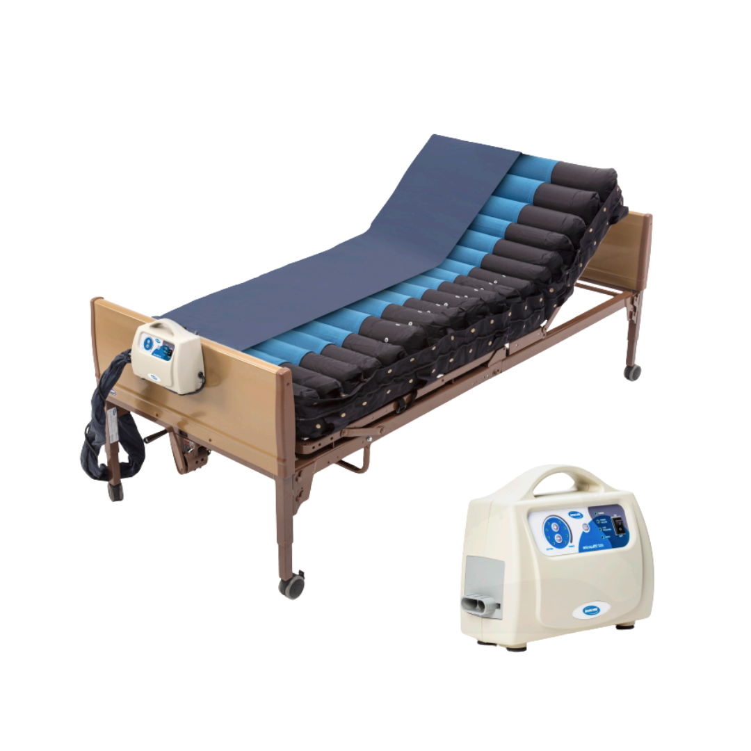 A hospital bed with the Invacare microAIR® MA500 Alternating Pressure Low Air Loss Mattress System and a control unit on the footboard; a second control unit is shown in the lower right corner.