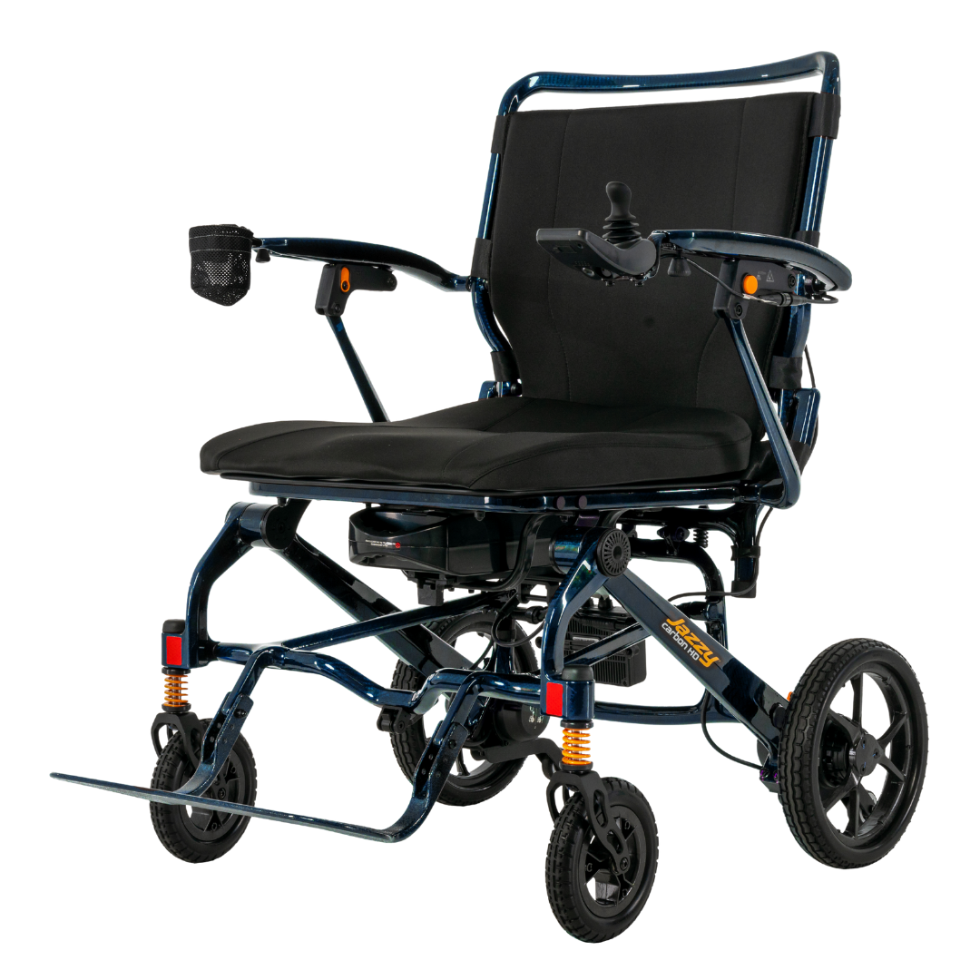 The Pride Jazzy Carbon HD Bariatric Portable Powerchair is a lightweight electric wheelchair with right-arm joystick, black seat and backrest, four wheels, and a mesh cup holder on the left—perfect travel power chair for convenient mobility.