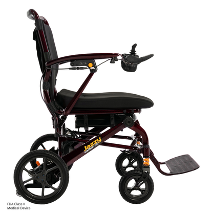 A maroon Pride Jazzy Carbon HD Bariatric Portable Powerchair shown from the side, featuring a black cushioned seat and backrest, armrests, joystick controller, footrest, large rear wheels, and smaller front wheels for smooth mobility.