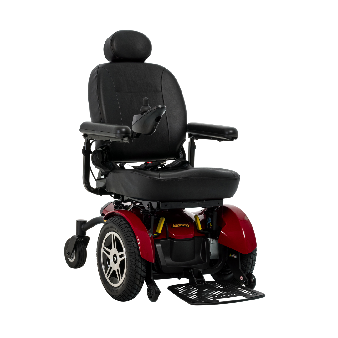 The Pride Mobility Jazzy® Elite HD Powerchair is a red and black heavy-duty electric wheelchair with a padded seat, armrests, footrest, headrest, and right-arm joystick control, shown on a white background.