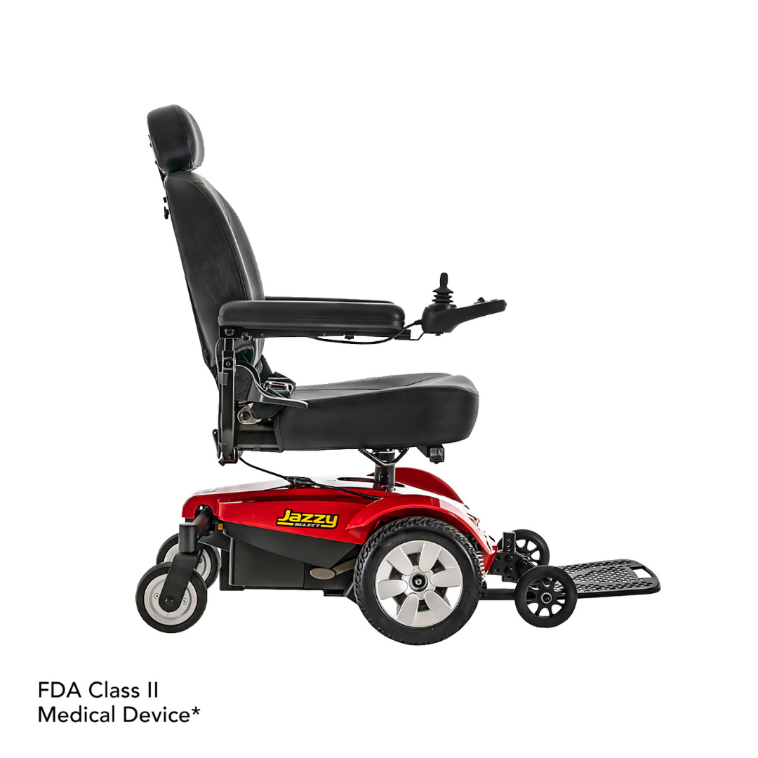 A Pride Mobility Jazzy Select® Powerchair in red and black is shown from the side, featuring a high backrest, armrests, joystick control, footrest, large rear wheels, and Jazzy logo on the base. Text: FDA Class II Medical Device*.