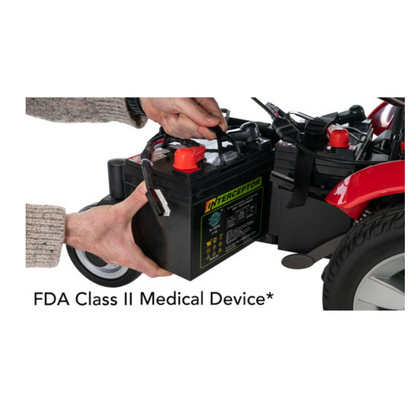 A person removes a large battery from a Pride Mobility Jazzy Select® Powerchair. Text below reads “FDA Class II Medical Device*”.