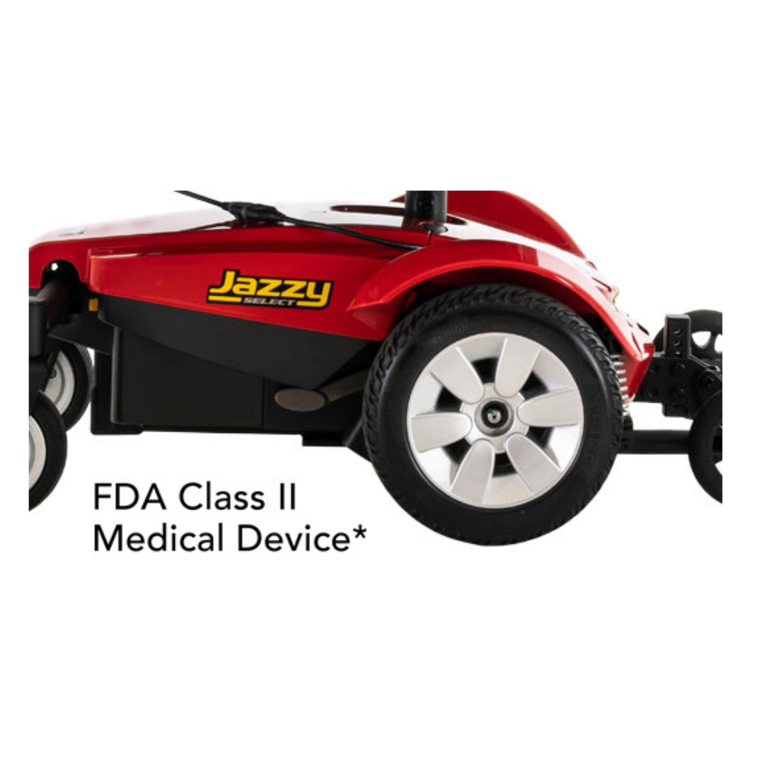 Close-up of a red Pride Mobility Jazzy Select® Powerchair with large rear wheels and “FDA Class II Medical Device*” text shown below the chair.