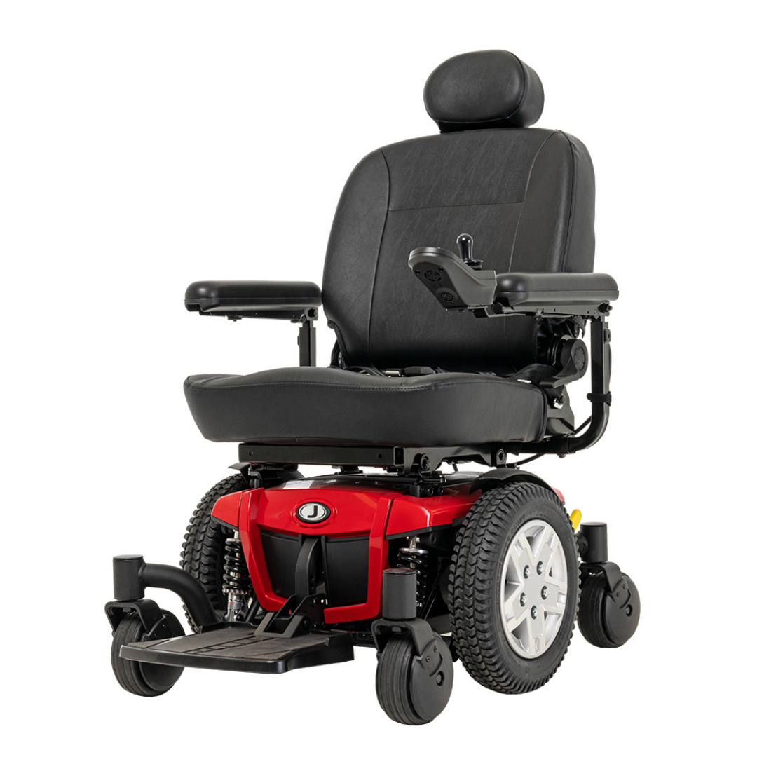 The Pride Mobility Jazzy® 600 ES Powerchair with ATX Suspension is a red and black powerchair featuring large rear wheels, padded seat, headrest, right-side joystick control, and Mid-Wheel 6® technology for superior maneuverability.