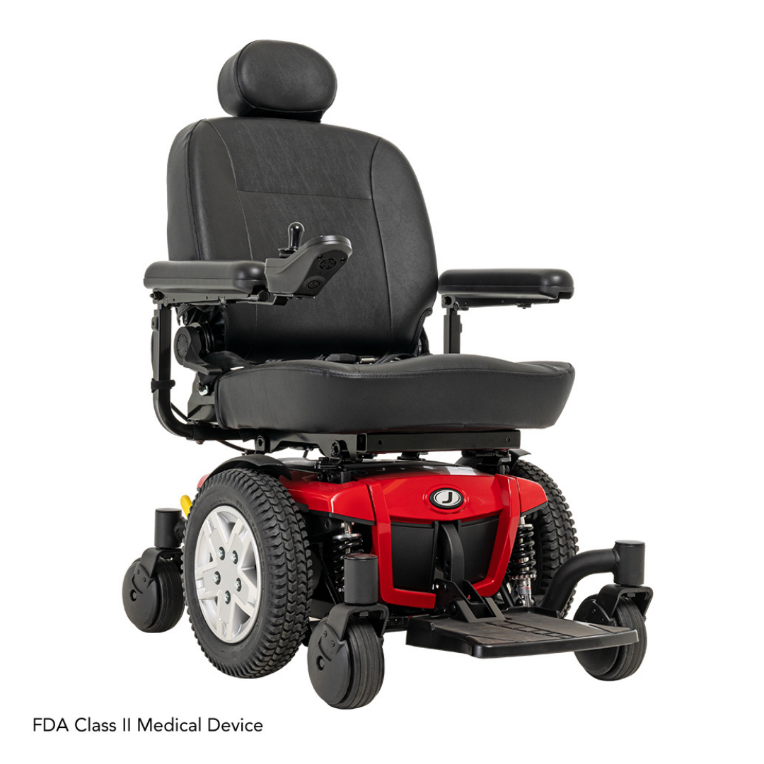The Pride Mobility Jazzy® 600 ES Powerchair with ATX Suspension features a red and black design, padded seat, headrest, armrests, footrest, Mid-Wheel 6® technology for maneuverability, and an armrest control panel for easy use.