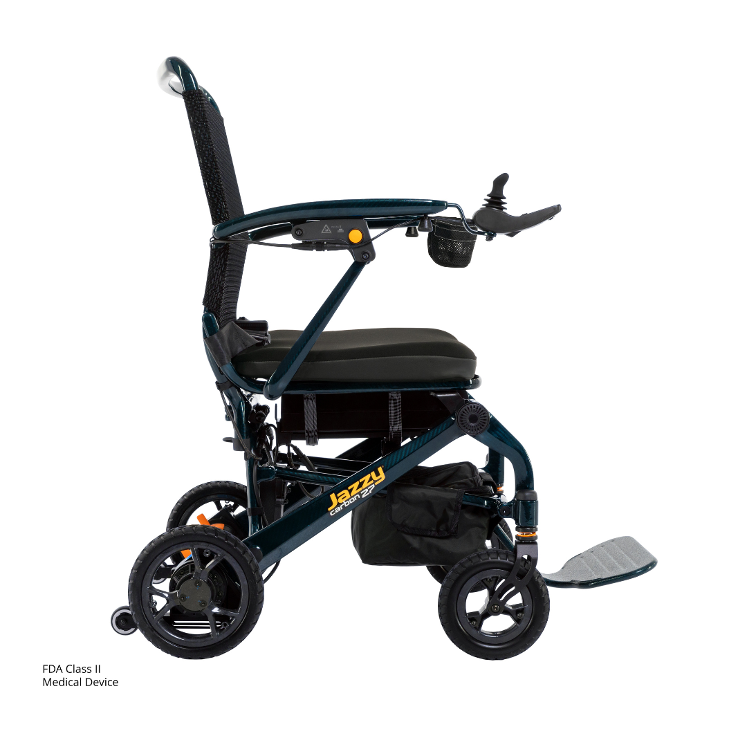 Discover the Jazzy® Carbon 27 Ultralite Portable Power Wheelchair—an ultra-lightweight carbon fiber chair with a black frame, cushioned seat, armrest joystick control, compact wheels, and under-seat storage pouch.