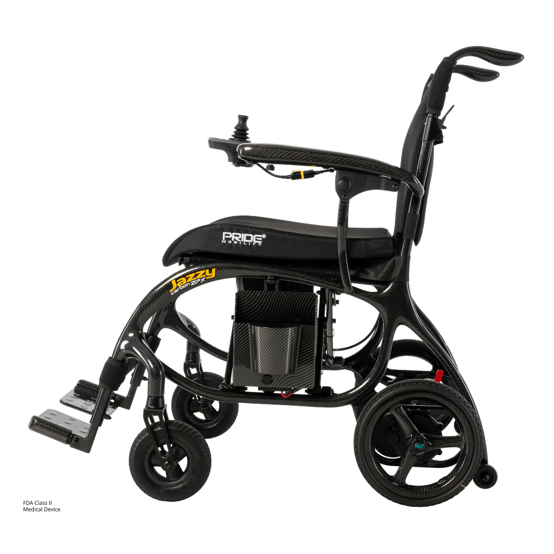 The Pride Jazzy® Carbon 27X Portable Power Wheelchair is a lightweight black chair with a cushioned seat, backrest, joystick armrest control, and four wheels, designed for convenient mobility.