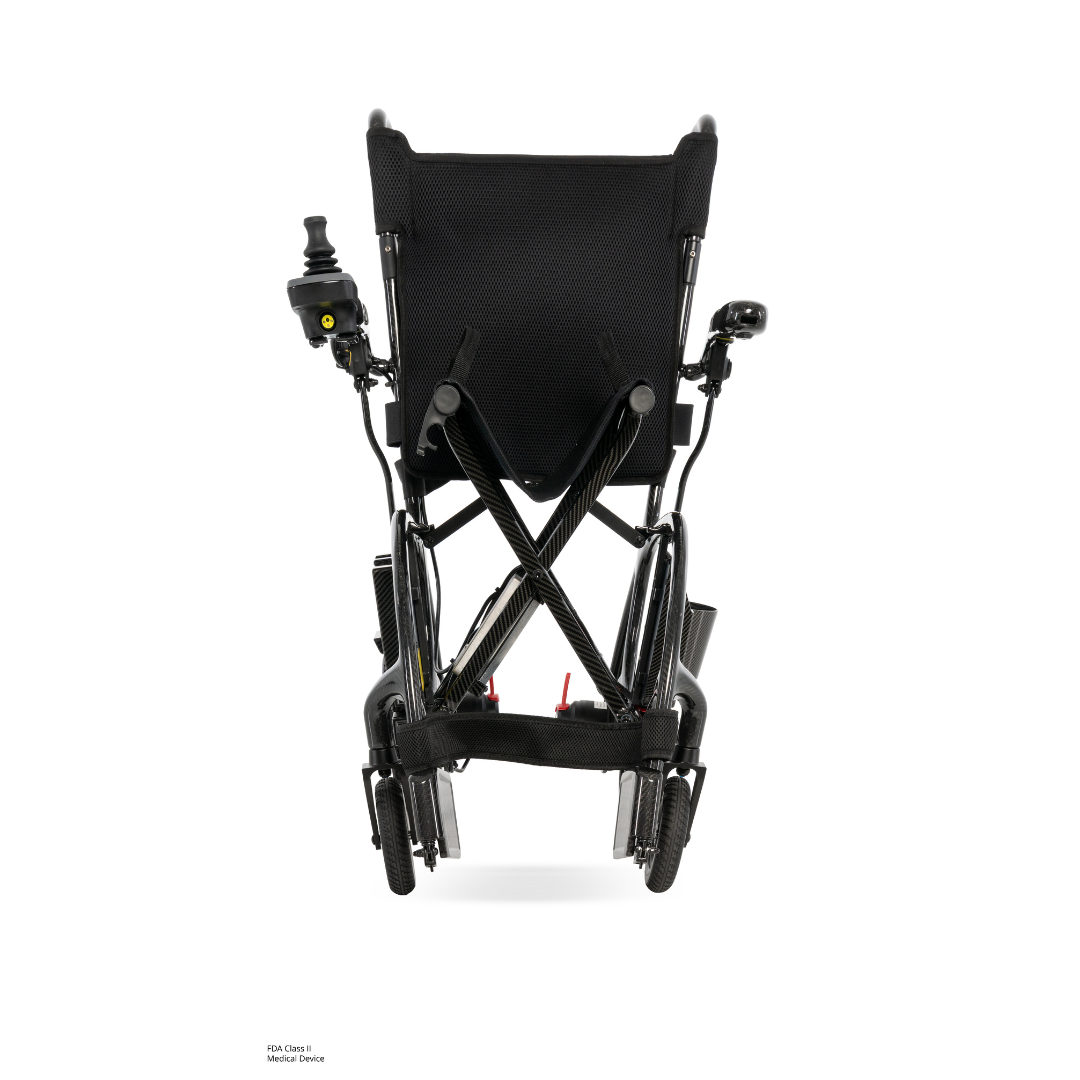 Rear view of the Pride Jazzy® Carbon 27X Portable Power Wheelchair, featuring a black ultra-lightweight frame, wheels, and a joystick control on the left armrest, set against a plain white background.