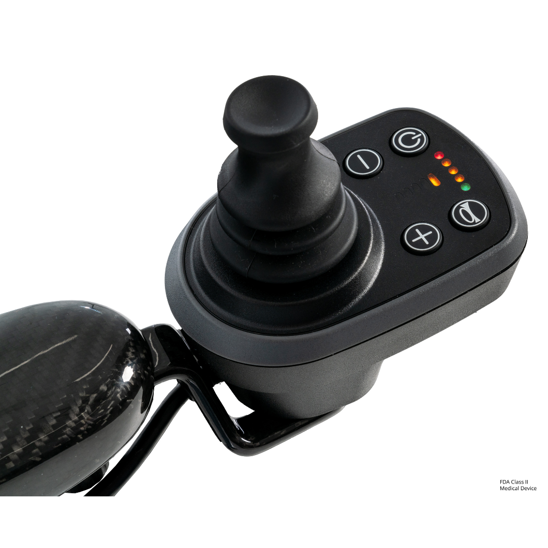 Close-up of a black joystick control panel with buttons and LED indicators, attached to a curved armrest on the Pride Jazzy® Carbon 27X Portable Power Wheelchair—an ultra-lightweight chair designed for comfort and travel.