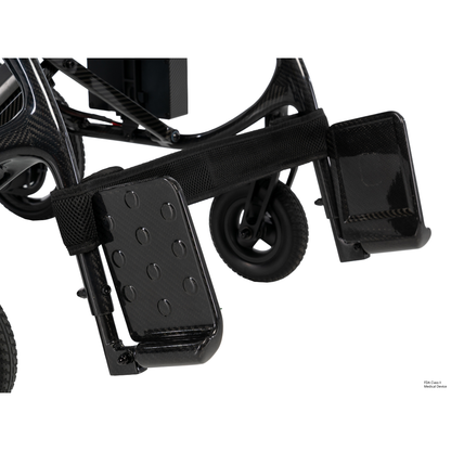 Close-up of the footrests and lower frame of the Pride Jazzy® Carbon 27X Portable Power Wheelchair, featuring textured black footplates and small front wheels on a white background.