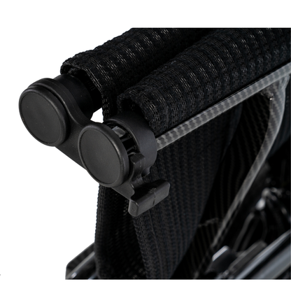 Close-up of the folded backrest and push handles on the black Pride Jazzy® Carbon 27X Portable Power Wheelchair, showcasing its textured fabric and tubular ultra-lightweight frame details.