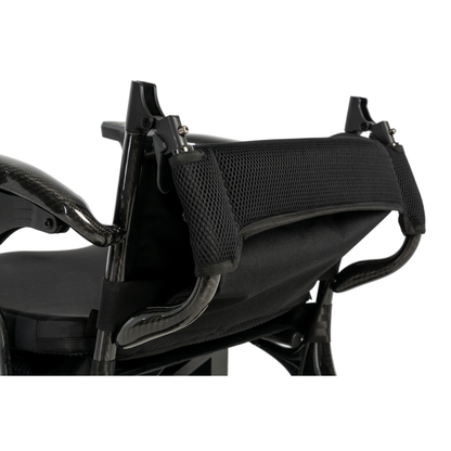 Close-up view of the backrest and handles of the Pride Jazzy® Carbon 27X Portable Power Wheelchair, showing its ultra-lightweight design with mesh and padded fabric back support plus a curved metal frame.