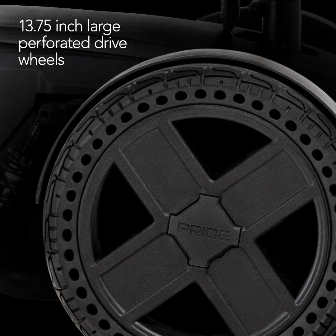 Close-up of a large, black perforated drive wheel labeled PRIDE, featured on the Pride Mobility Jazzy® EVO 614 HD Bariatric Powerchair with ATX Suspension. Text highlights 13.75-inch large perforated drive wheels for your power wheelchair.