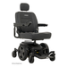 The Pride Mobility Jazzy® EVO 614 HD Bariatric Powerchair with ATX Suspension is a black heavy-duty wheelchair featuring a padded seat, backrest, headrest, armrests, large rear wheels, small front wheels, and right-arm joystick control.