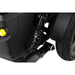 Close-up of the black suspension spring and wheel on the Pride Mobility Jazzy® EVO 614 HD Bariatric Powerchair with ATX Suspension, featuring a yellow knob and highlighting its shock absorber and tire tread for enhanced comfort.