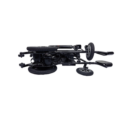 A folded Journey Air Elite Folding Carbon Fiber Powerchair weighing only 29 lbs lies on its side, showcasing its travel-friendly design with visible wheels and handles, perfect for easy storage or transport.