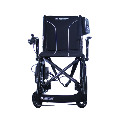 Front view of the Journey Air Elite Max Ultralite Carbon Fiber Travel Powerchair, a comfortable, lightweight mobility chair with armrests, footrest, joystick control, and visible Air Elite and Journey branding.