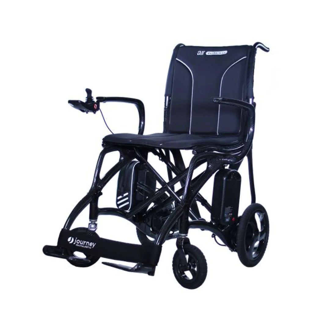 The Journey Air Elite Max Ultralite Carbon Fiber Travel Powerchair is a lightweight black mobility chair with armrests, a padded seat, left-side joystick control, small wheels, and the Journey logo on the footrest.