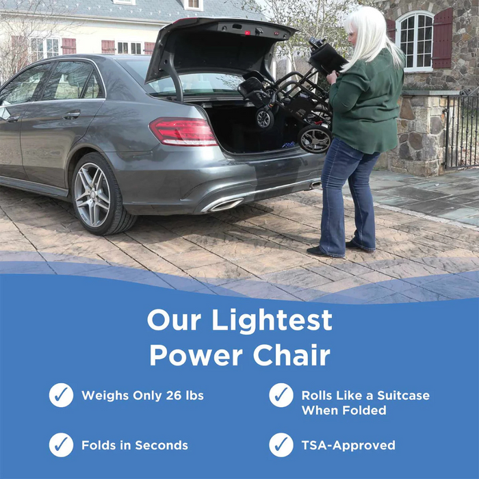 A person lifts the Journey Air Elite Folding Lightweight Powerchair into a car trunk. It weighs 29 lbs, folds in seconds, rolls like a suitcase when folded, and is TSA-approved for seamless indoor navigation and portability.