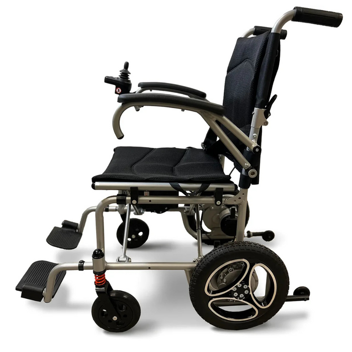 Side view of the Journey Air Lightweight Folding Powerchair, weighing just 37 lbs, with a sleek metallic frame and black padded seat. It features joystick control, footrests, and large rear wheels with suspension for modern mobility in a portable wheelchair design.