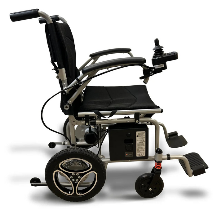 The Journey Air Lightweight Folding Powerchair, weighing just 37 lbs, is shown in black and silver from the side. It features a dual-drive system, cushioned seat, armrests, joystick control, and two large rear wheels with a suspension system in a modern and compact design.